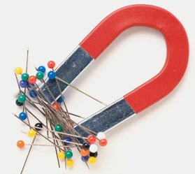 Horseshoe magnet attracting pins