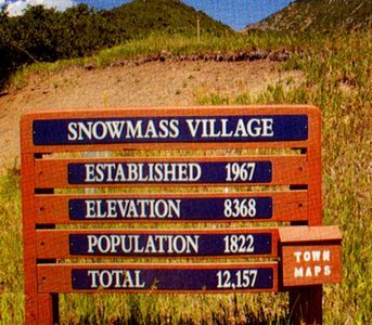 A sign showing the establishment year, elevation, population, and total for Snowmass Village, illustrating the error of adding quantities with different units