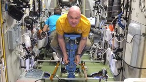 Astronaut using mass measurement device