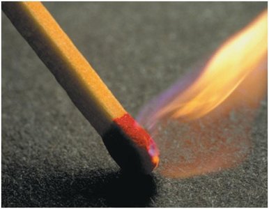 Hand striking a match, producing thermal energy.