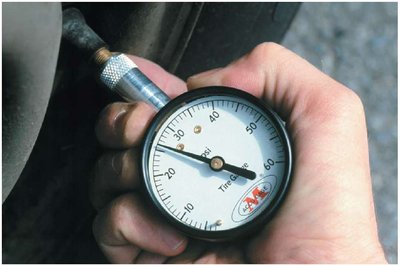 A tire-pressure gauge reads the gauge pressure