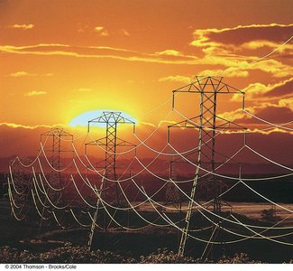High-voltage power transmission lines at sunset