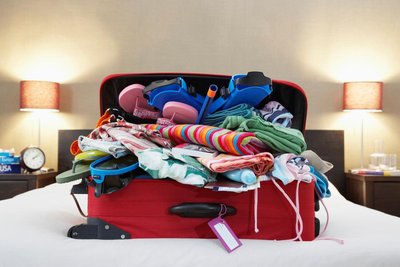 Suitcase packed with clothes, illustrating the concept of density