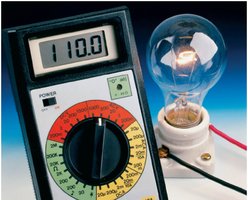 Digital multimeter measuring voltage across a light bulb