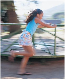 Child running on a merry-go-round
