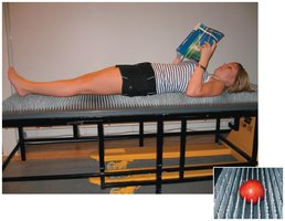 Person lying on a bed of nails, demonstrating distributed pressure