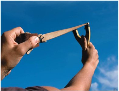A slingshot being pulled, illustrating work and potential energy