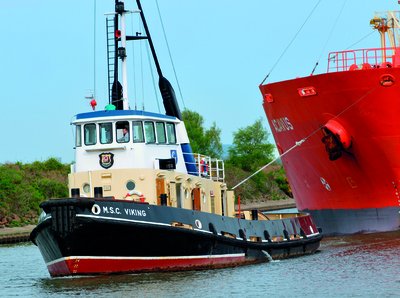 Tugboat pulling a ship, illustrating forces in action