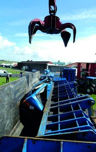 Crane crushing a car, showing permanent deformation
