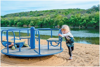 Child pushing a merry-go-round