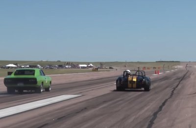 Drag racing cars illustrating 1D motion