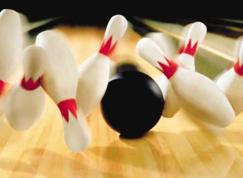 Bowling ball striking pins