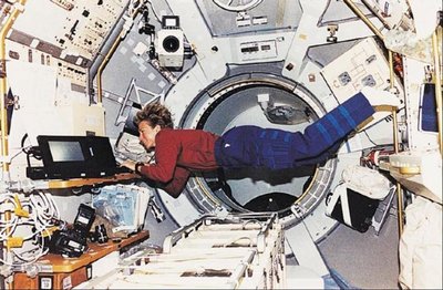 Astronaut floating in spacecraft, demonstrating weightlessness