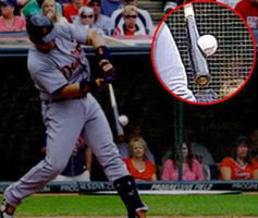 Baseball player hitting a ball with a bat