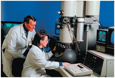 Scientists using an electron microscope
