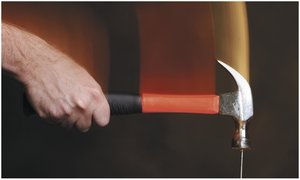 Hammer striking a nail, illustrating action/reaction forces
