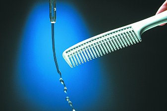 A charged comb deflecting a stream of water