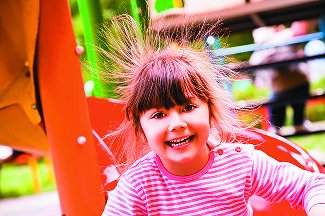 Child with hair standing up due to static electricity