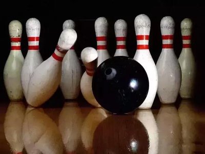 Bowling ball striking pins, illustrating momentum transfer