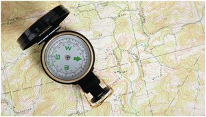 Compass on a map illustrating Earth's magnetic field