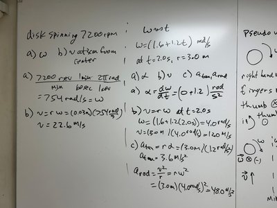 Whiteboard with calculations for angular velocity and linear velocity of a spinning disk