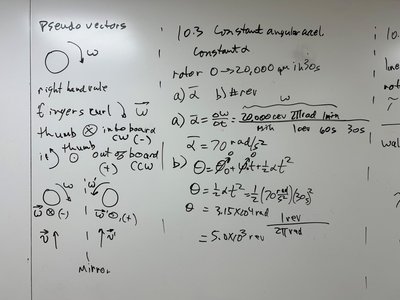 Whiteboard with angular acceleration and displacement calculations