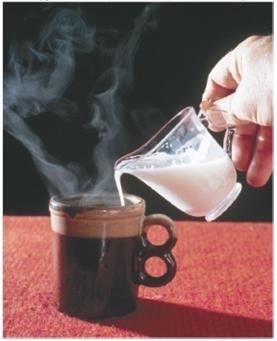 Pouring milk into coffee, illustrating heat transfer