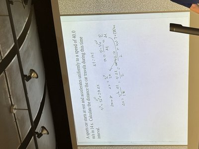 Handwritten kinematics solution for a car accelerating from rest