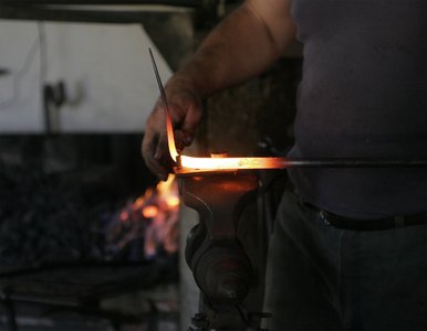 Blacksmith heating metal