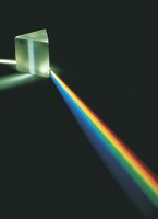 Prism dispersing white light into a rainbow