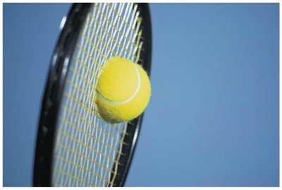Tennis ball colliding with racket