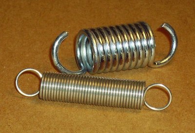 Photograph of two metal springs, one intact and one broken, illustrating real springs as physical objects