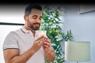 Person smelling a cup, illustrating olfactory sense