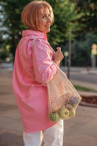 Woman carrying groceries, illustrating weight perception
