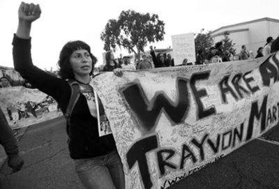 Protestor holding Trayvon Martin banner