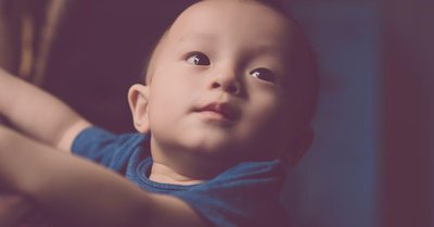 Infant scanning a toy, illustrating early visual exploration