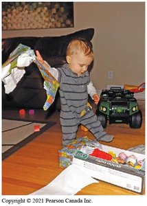 Infant crawling on a play mat, demonstrating early motor skills