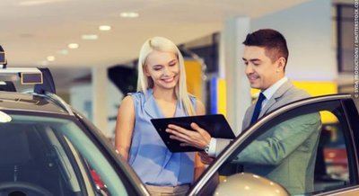 Car salesperson with a customer, illustrating the low-balling technique