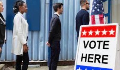 People waiting in line to vote, illustrating effort justification