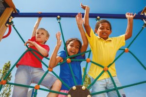 Children climbing on playground equipment, demonstrating gross motor skills