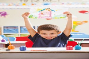 Child holding up a drawing, showing advanced fine motor skills