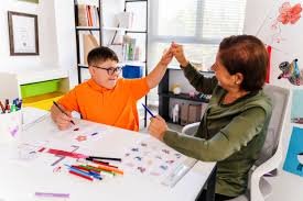 Teacher giving student a high five, direct reinforcement