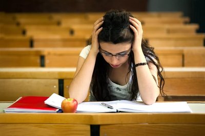 A student experiencing stress in an academic setting, representing daily hassles