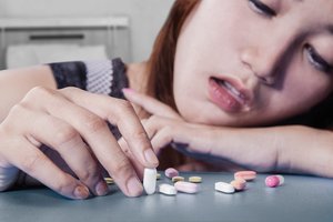 Person with pills, illustrating drug dependence