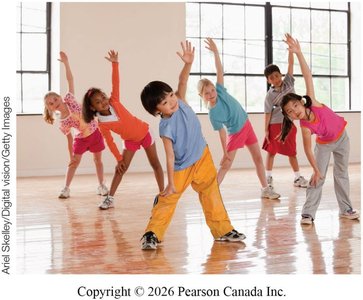 Children practicing gross motor skills in a gym