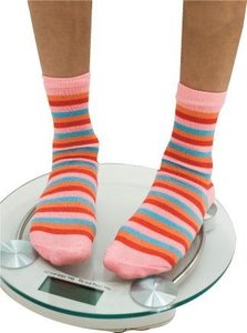 Person standing on a scale, illustrating measurement