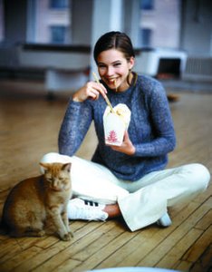 Woman eating alone, illustrating emotional eating