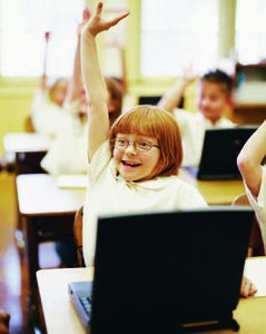 Student raising hand, illustrating need for achievement