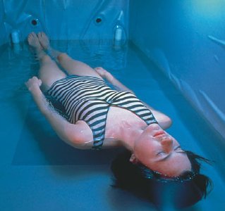 Person in a flotation tank experiencing sensory deprivation