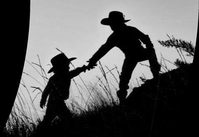 One child helping another up a hill